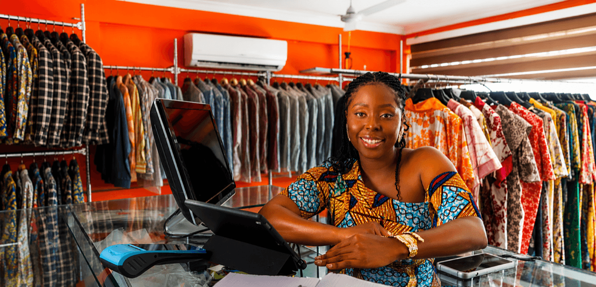 African shop owner using a point-of-sale system at her retail store